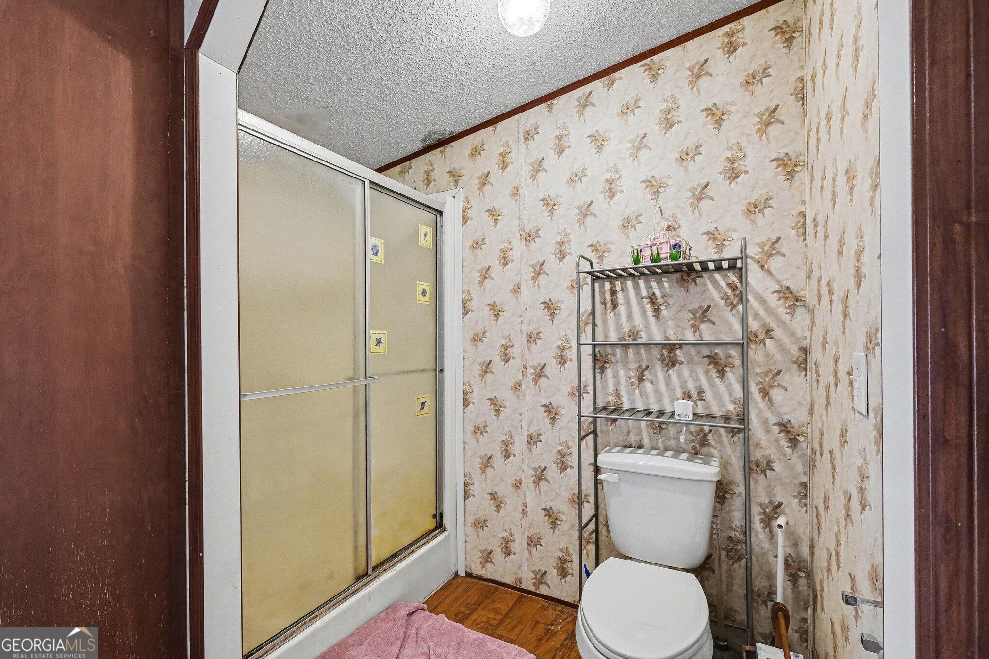 109 Mill Run Comer, GA 30629 - Photo 13 of 23 a bathroom with a toilet and a shower curtain