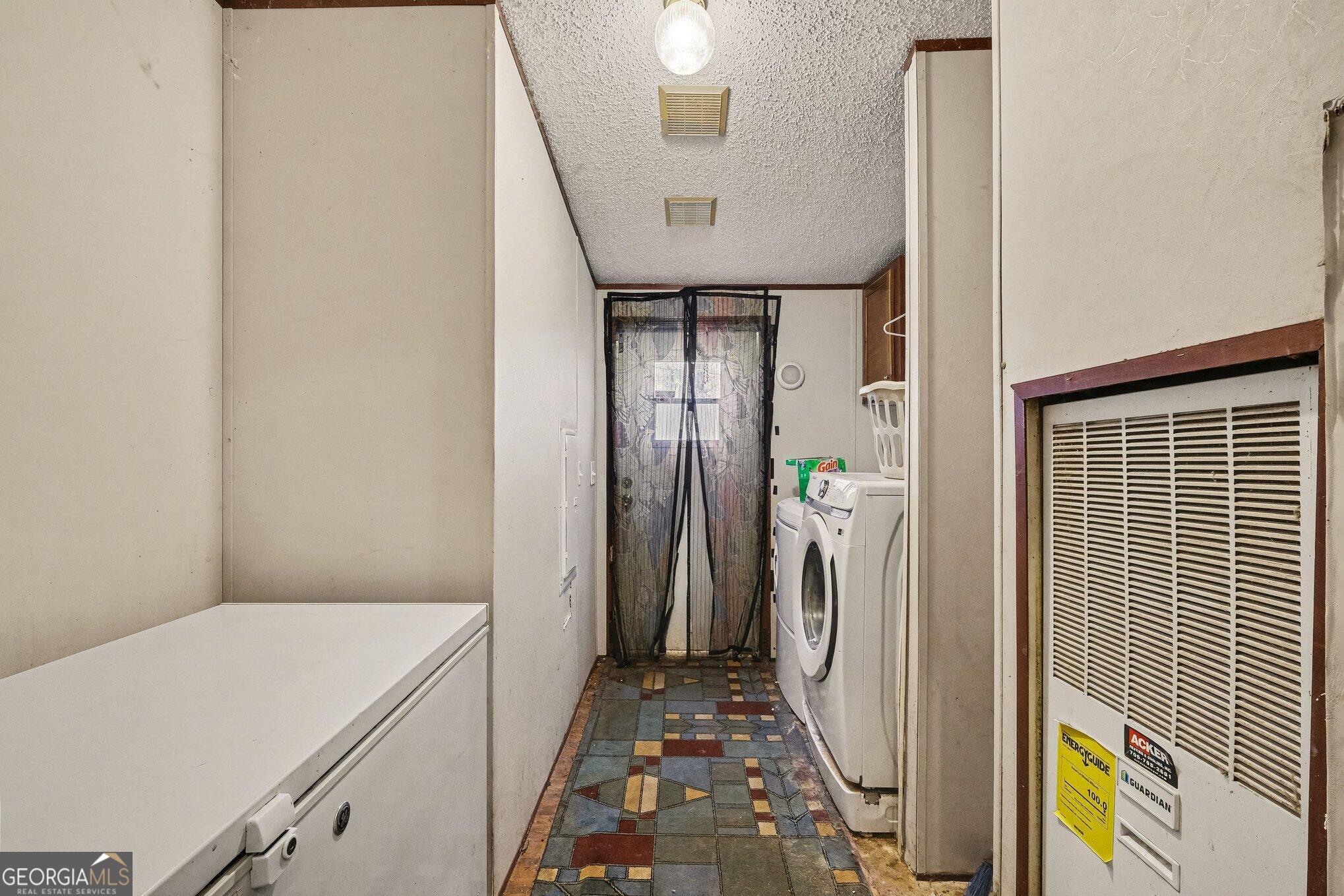 109 Mill Run Comer, GA 30629 - Photo 14 of 23 a view of a hallway with washer and dryer
