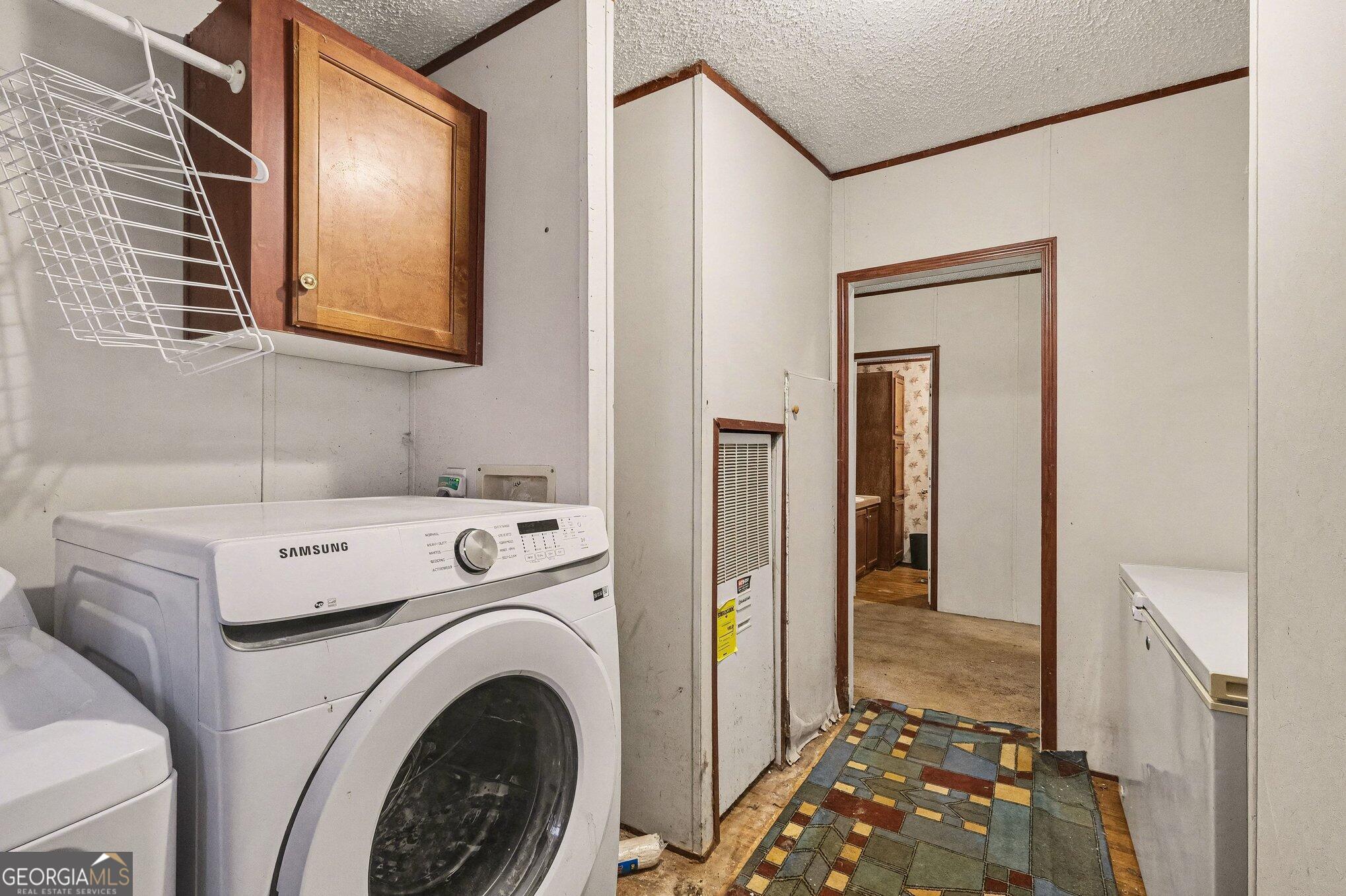 109 Mill Run Comer, GA 30629 - Photo 15 of 23 a view of washer and dryer with bathroom in the background
