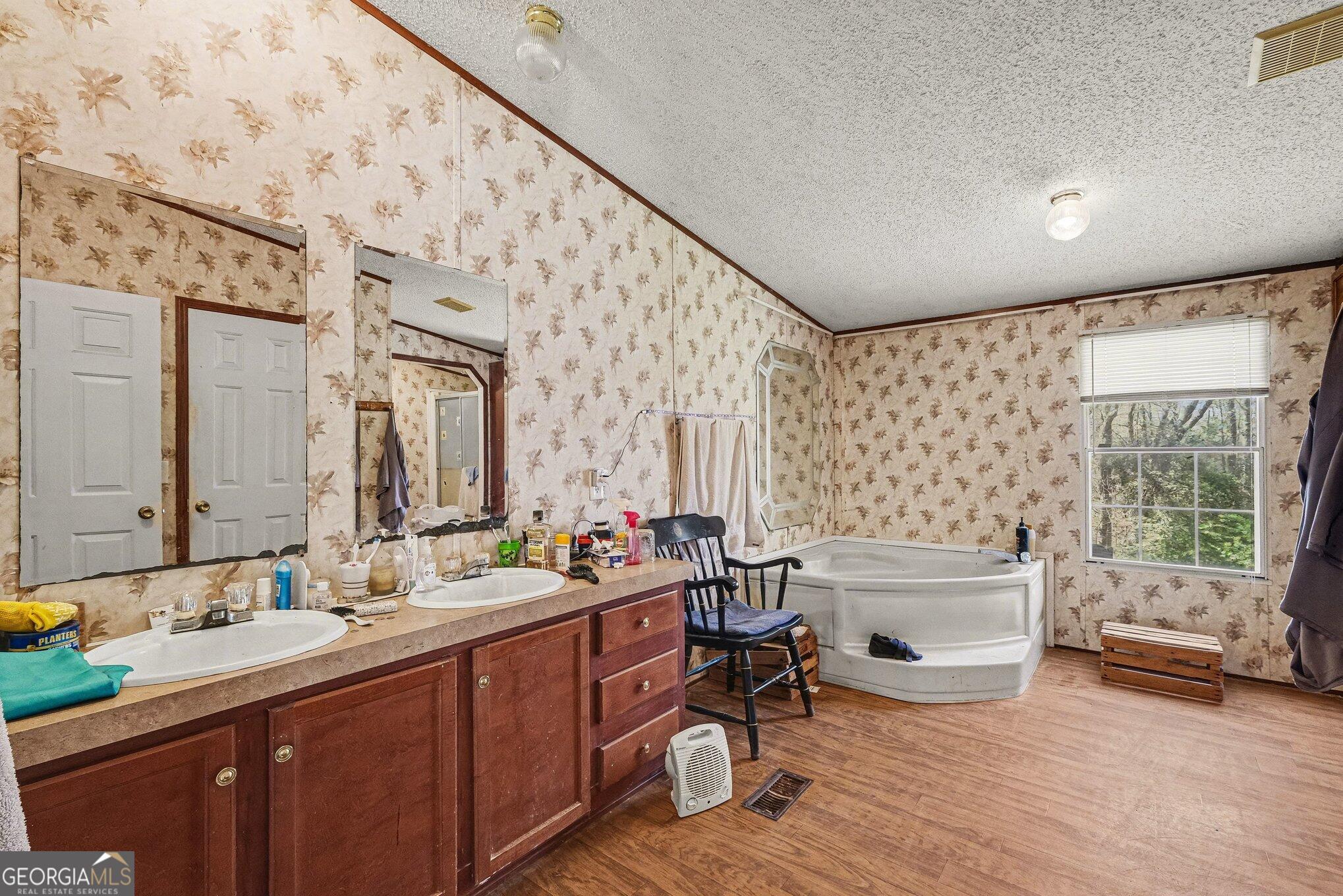 109 Mill Run Comer, GA 30629 - Photo 16 of 23 a bathroom with a tub sink and mirror