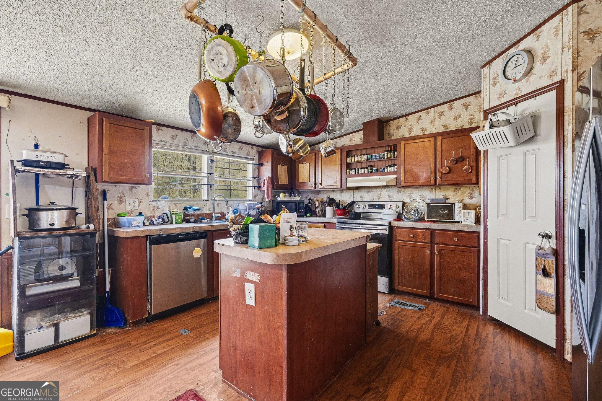 109 Mill Run Comer, GA 30629 - Photo 6 of 23 a kitchen with stainless steel appliances granite countertop a large stove a sink dishwasher and a refrigerator with wooden floor