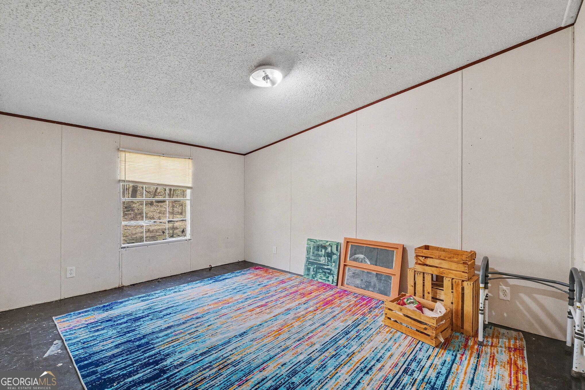 109 Mill Run Comer, GA 30629 - Photo 8 of 23 a view of a livingroom with an empty space and wooden floor