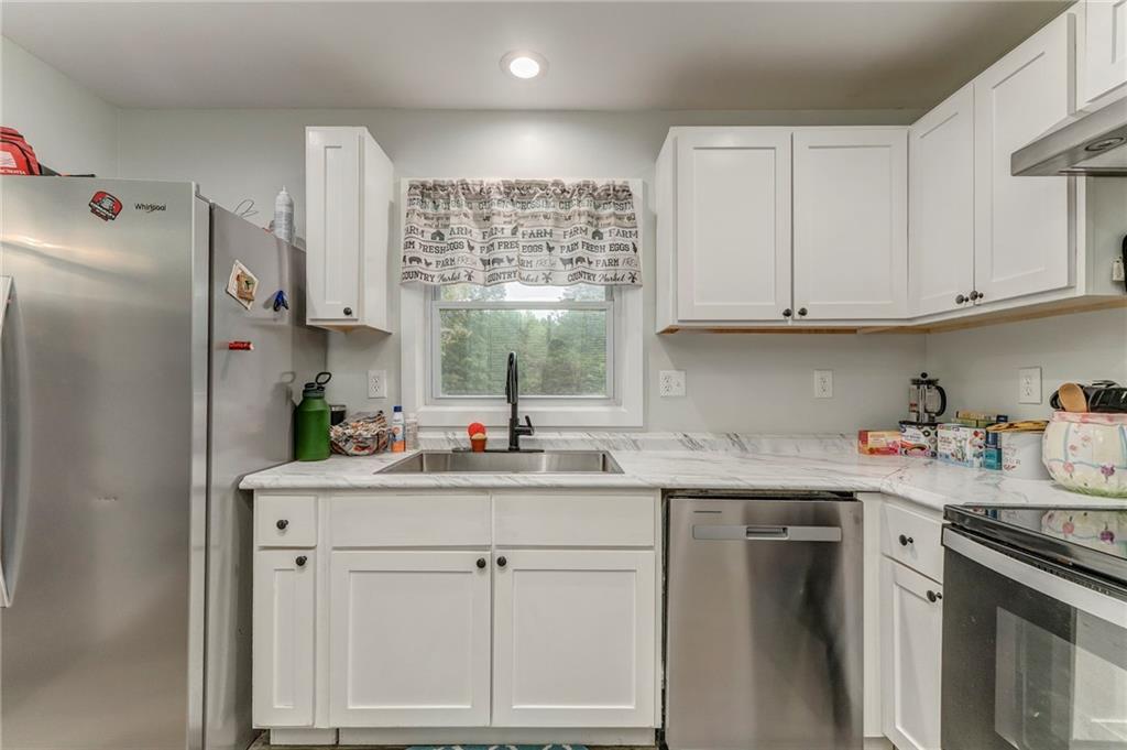 2020 Old Cedartown Road Cedartown, GA 30125 - Photo 15 of 33 a kitchen with stainless steel appliances granite countertop a sink stove and cabinets