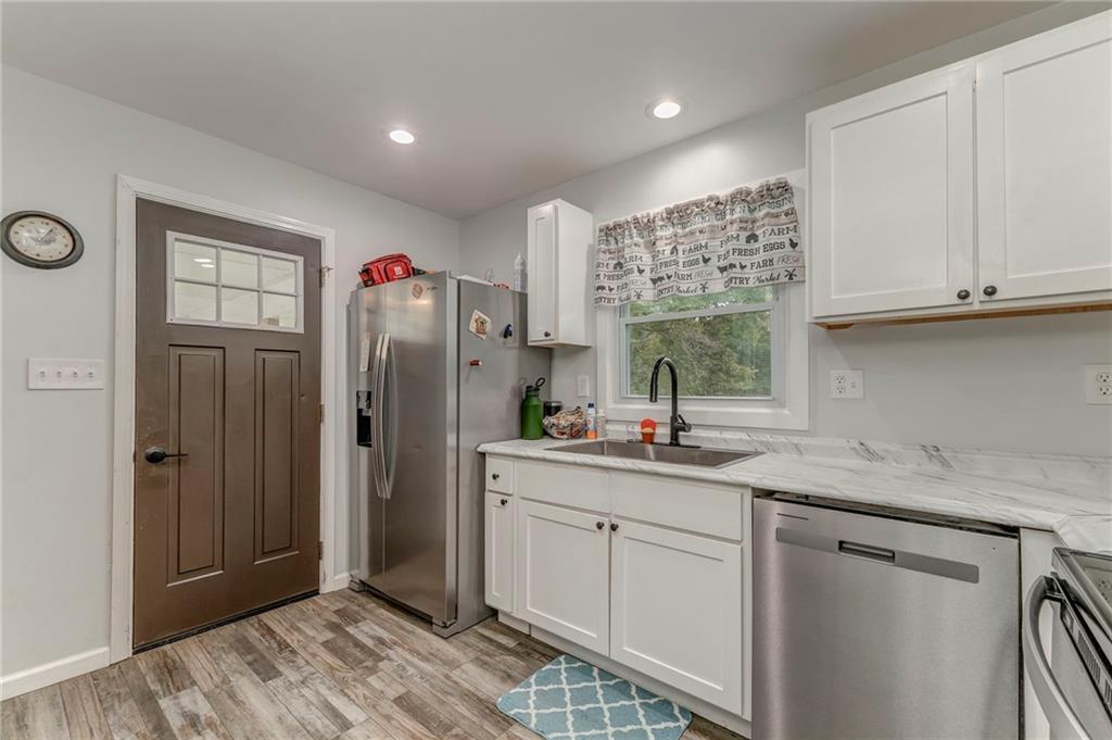 2020 Old Cedartown Road Cedartown, GA 30125 - Photo 16 of 33 a kitchen with stainless steel appliances granite countertop a refrigerator sink and cabinets