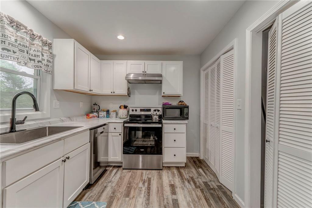2020 Old Cedartown Road Cedartown, GA 30125 - Photo 17 of 33 a kitchen with sink a stove and cabinets