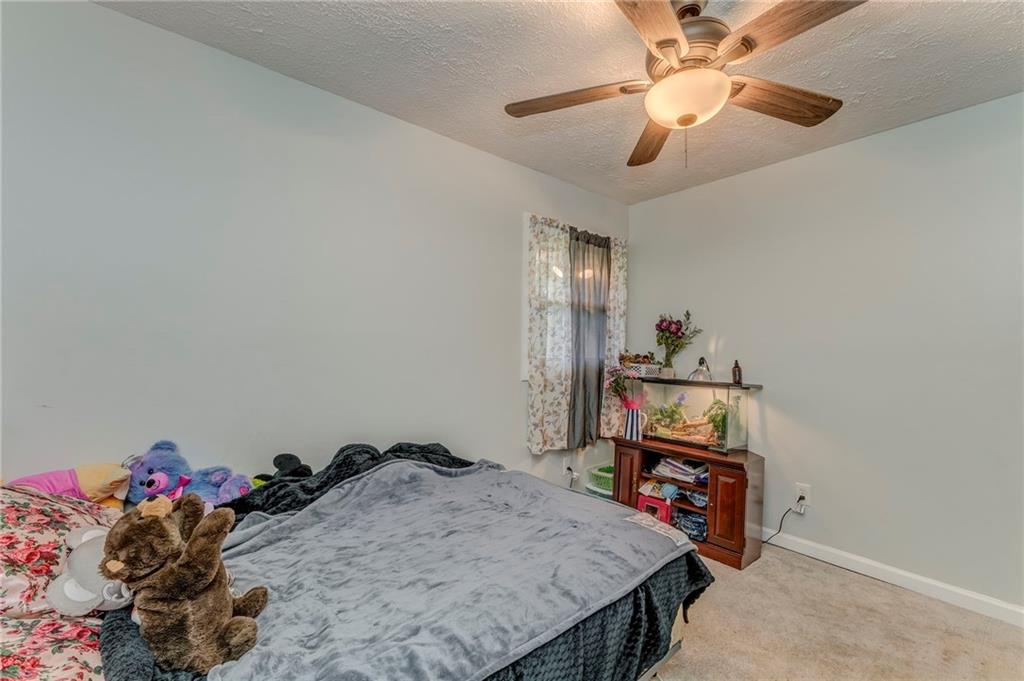 2020 Old Cedartown Road Cedartown, GA 30125 - Photo 19 of 33 a bedroom with a bed and a chandelier