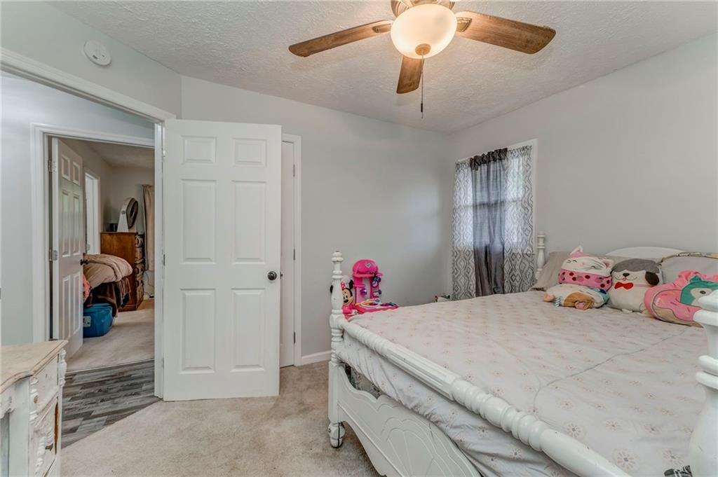 2020 Old Cedartown Road Cedartown, GA 30125 - Photo 22 of 33 a bedroom with a bed and a chandelier