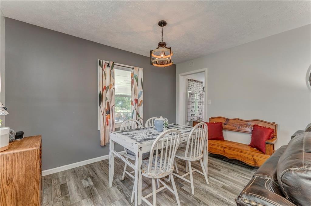 2020 Old Cedartown Road Cedartown, GA 30125 - Photo 10 of 33 a dining room with furniture a chandelier and wooden floor