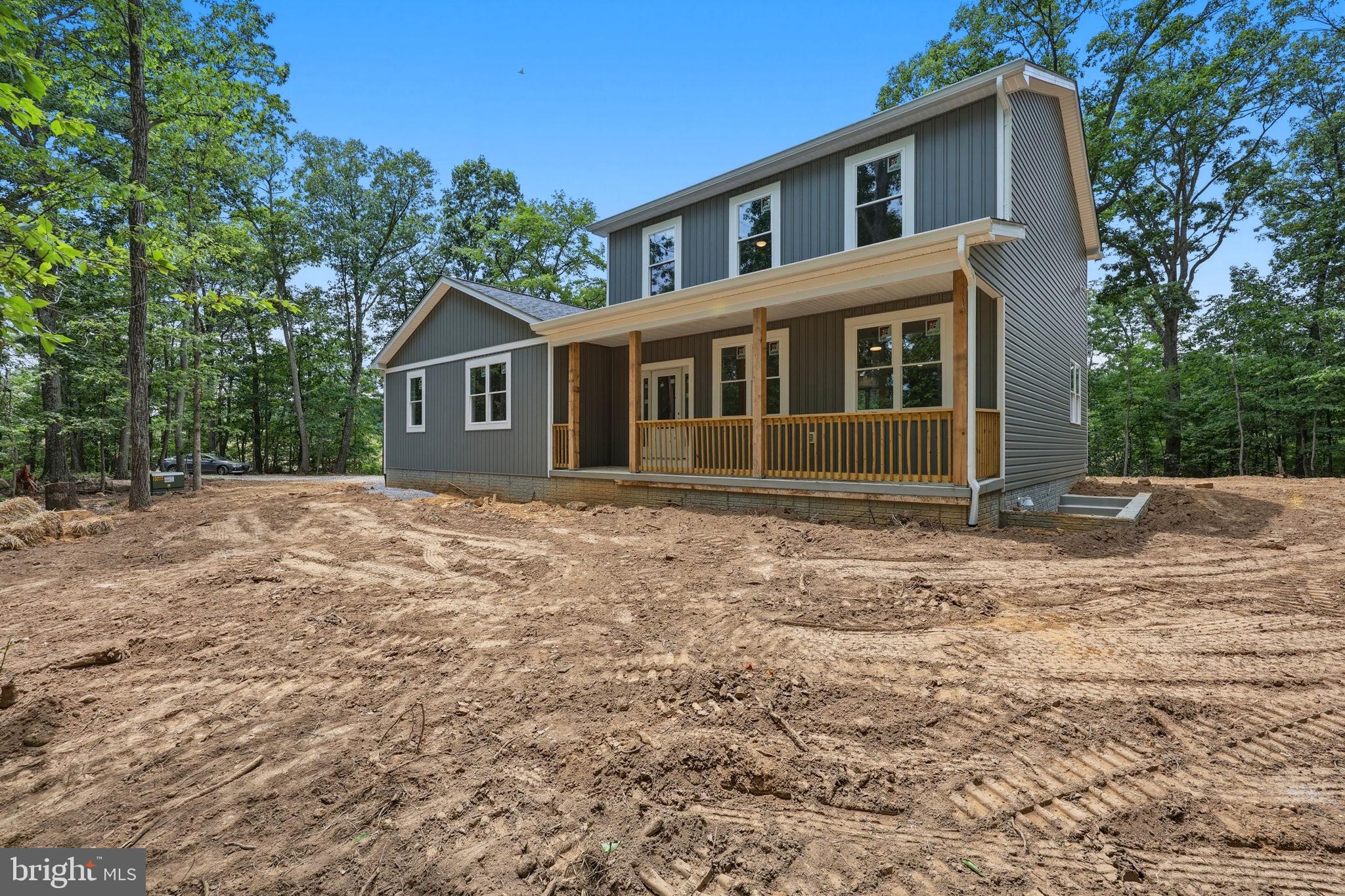 10339 Back Creek Valley Road Hedgesville, WV 25427 - Photo 3 of 48 a front view of a house with a garden