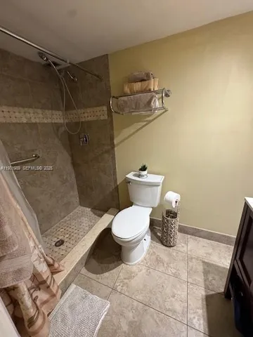a bathroom with a sink vanity mirror and toilet
