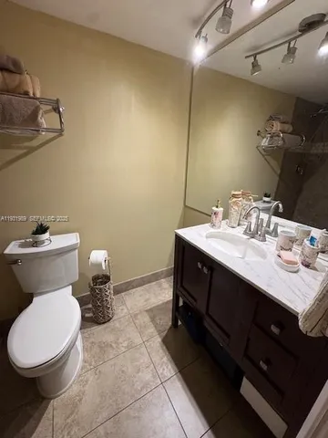 a bedroom with a bed and large windows