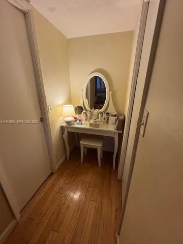 a bathroom with a sink a toilet a mirror and shower