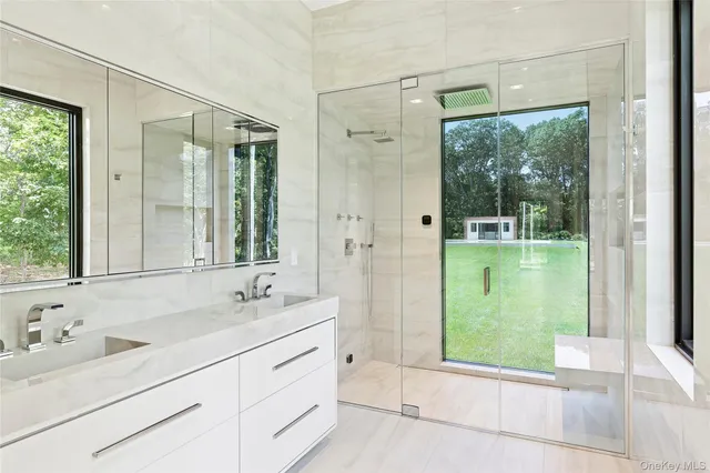 a bathroom with a double vanity sink and mirror