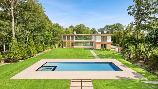 a view of yard with swimming pool and green space