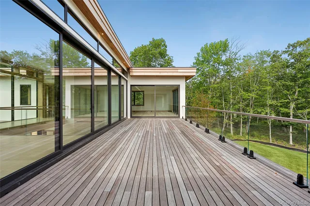 a view of balcony with a large window and wooden floor