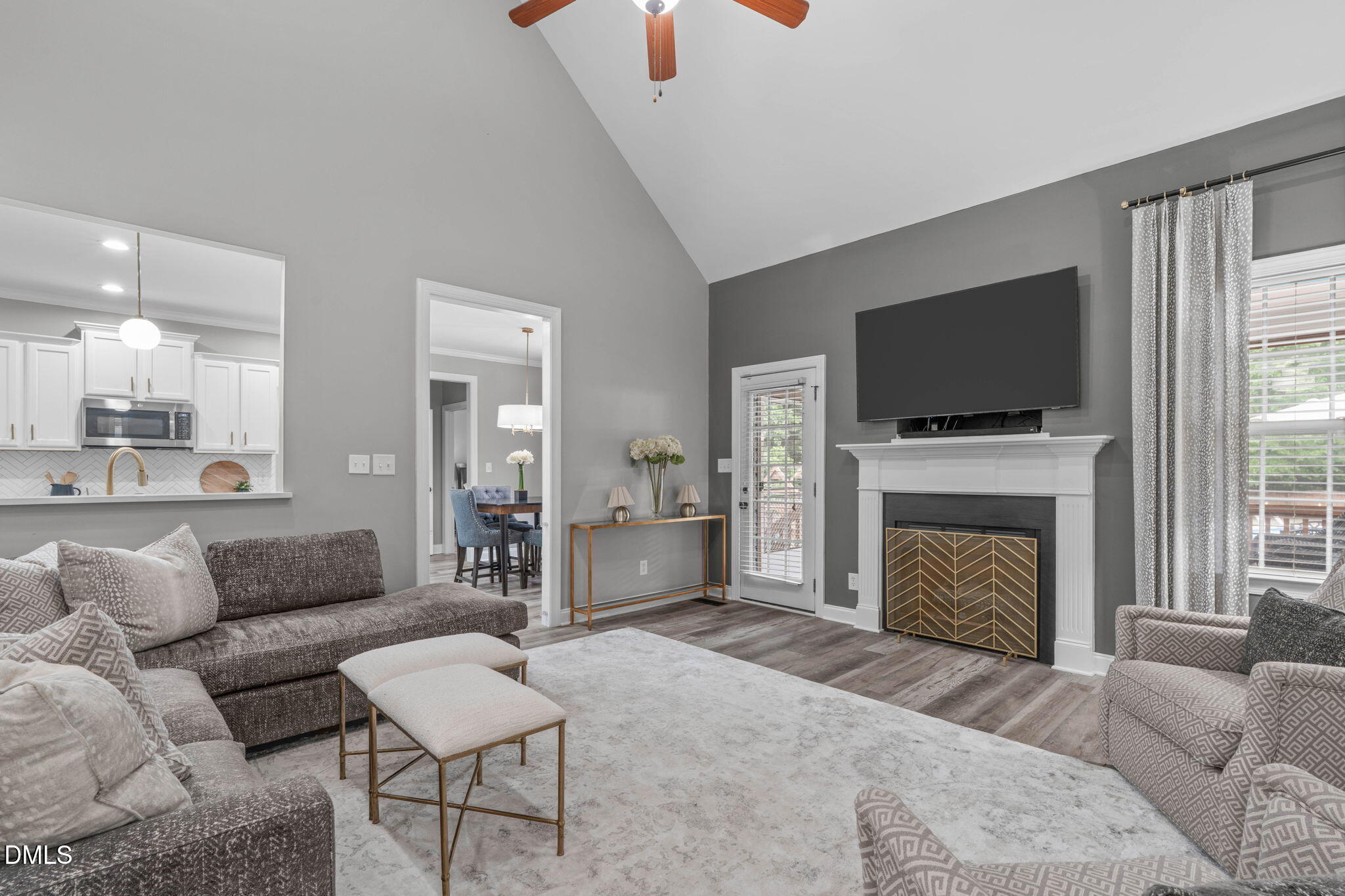 2450 Rolling Tracks Road Willow Spring, NC 27592 - Photo 13 of 64 a living room with furniture a fireplace and a flat screen tv