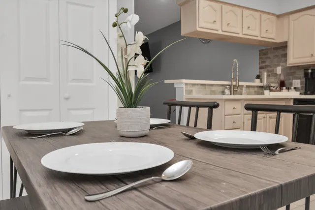 a kitchen with a sink white cabinets and stainless steel appliances
