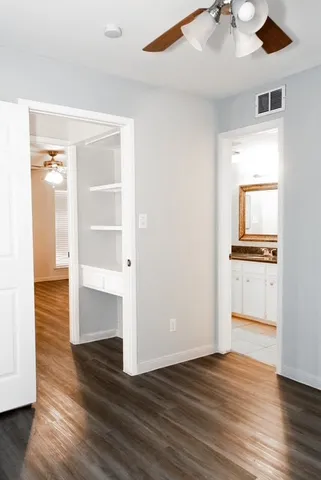 a view of a room with wooden floor