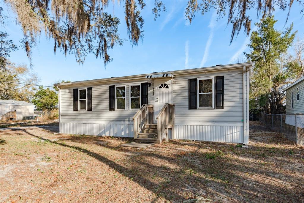 6707 Celeste Lane New Port Richey, FL 34653 - Photo 1 of 21 a view of a house with a yard