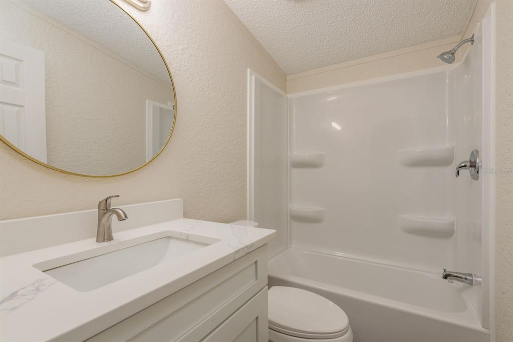 6707 Celeste Lane New Port Richey, FL 34653 - Photo 16 of 21 a bathroom with a granite countertop sink toilet and shower