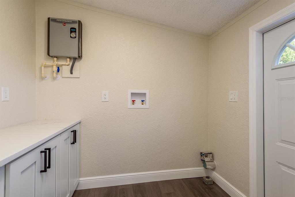 6707 Celeste Lane New Port Richey, FL 34653 - Photo 19 of 21 a view of a hallway with washer and dryer