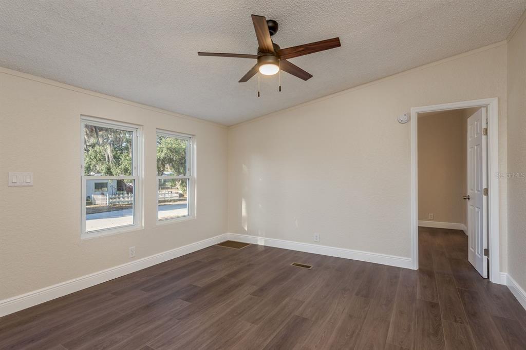 6707 Celeste Lane New Port Richey, FL 34653 - Photo 4 of 21 a view of an empty room with wooden floor and a window