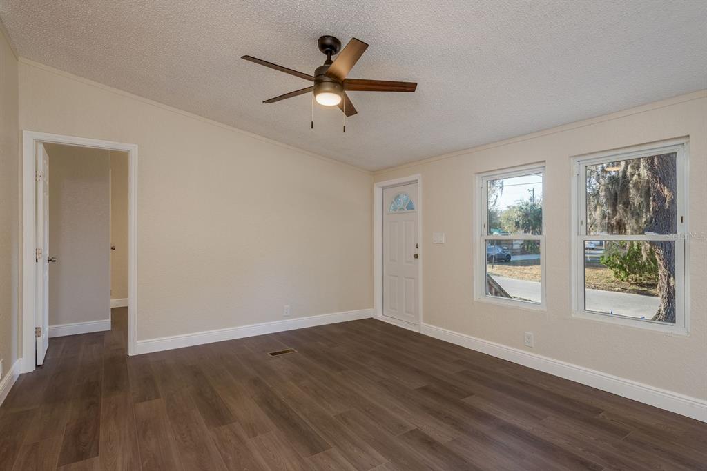 6707 Celeste Lane New Port Richey, FL 34653 - Photo 5 of 21 a view of an empty room with wooden floor and a window