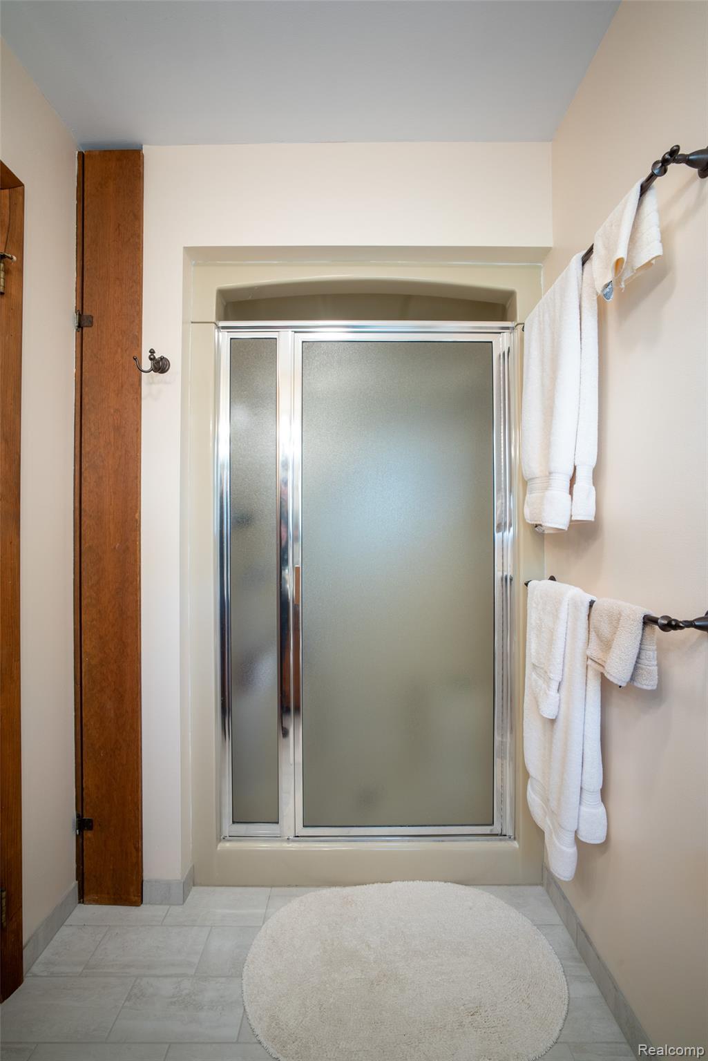 6240 Lakeshore Road Palms, MI 48465 - Photo 17 of 38 Full bath featuring a stall shower and baseboards