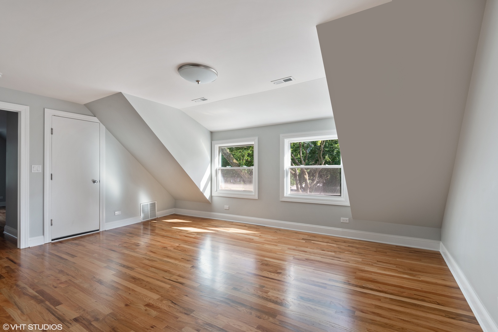 1131 Ridge Road, Unit 2 Wilmette, IL 60091 - Photo 4 of 11 an empty room with wooden floor and windows