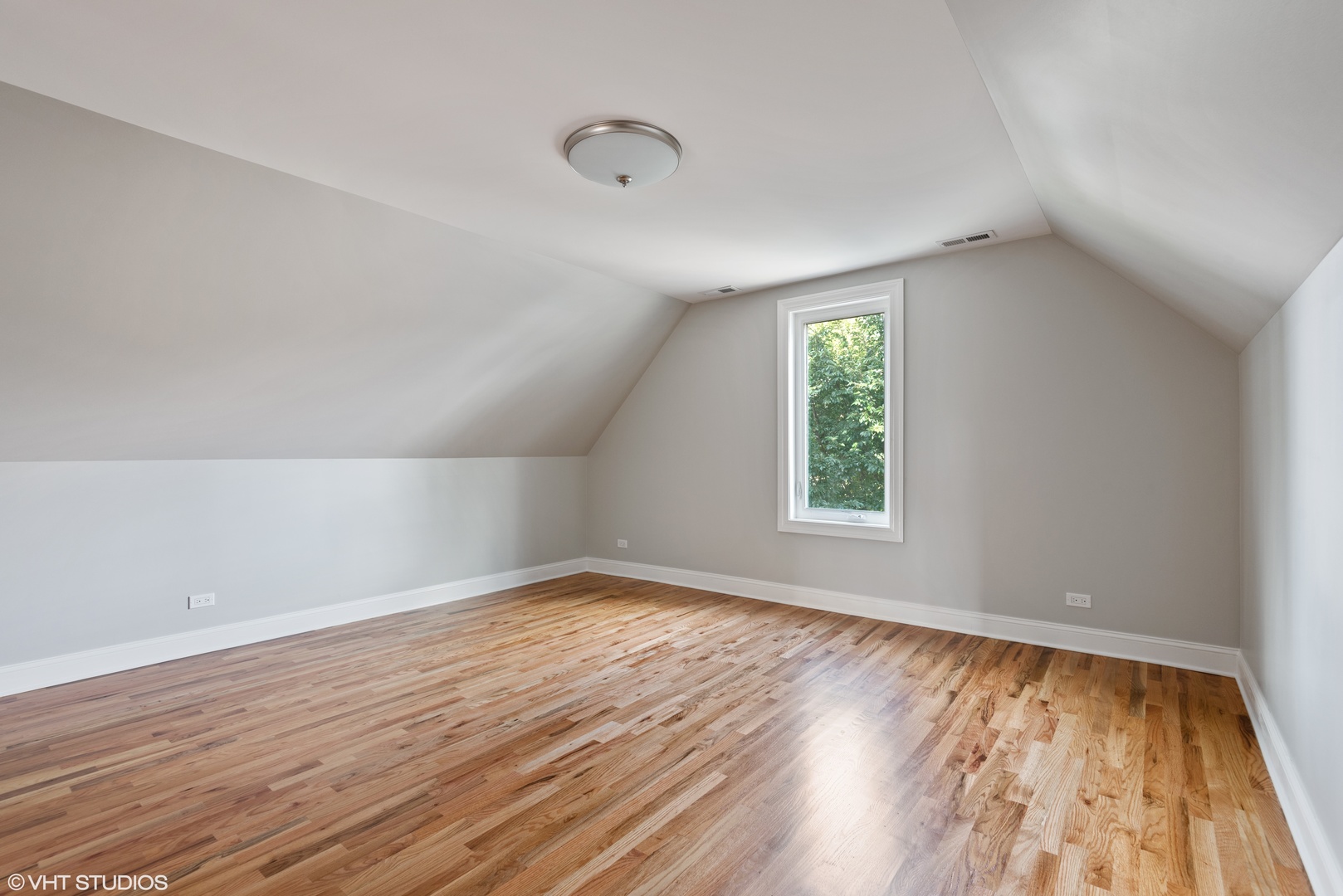 1131 Ridge Road, Unit 2 Wilmette, IL 60091 - Photo 7 of 11 an empty room with wooden floor and windows