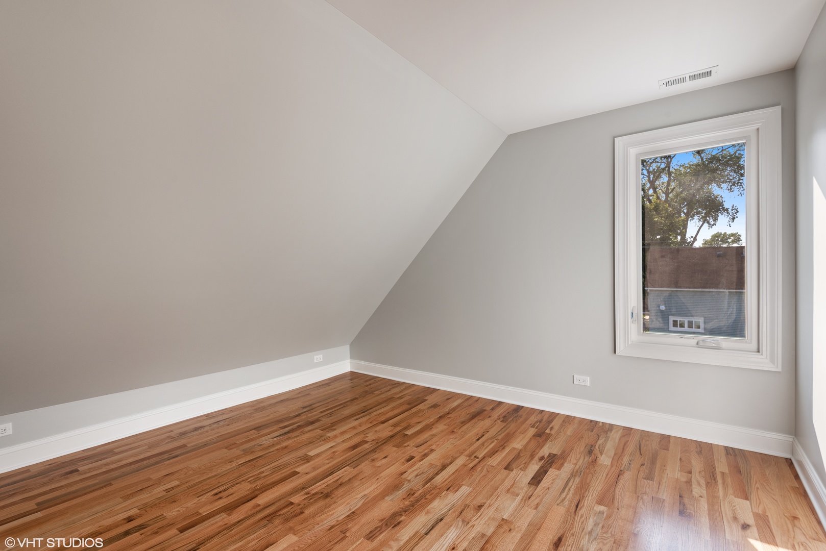 1131 Ridge Road, Unit 2 Wilmette, IL 60091 - Photo 9 of 11 an empty room with wooden floor and a window