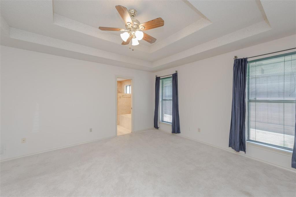 1106 Derby Run Carrollton, TX 75007 - Photo 13 of 26 an empty room with chandelier fan