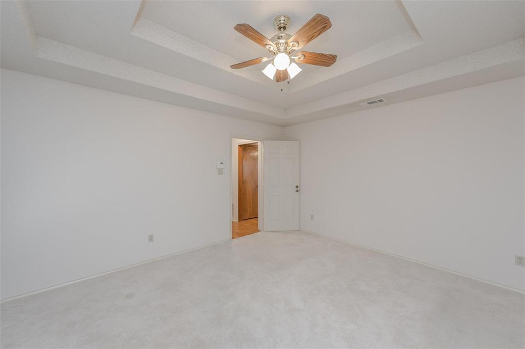 1106 Derby Run Carrollton, TX 75007 - Photo 15 of 26 an empty room with a chandelier fan and a ceiling fan