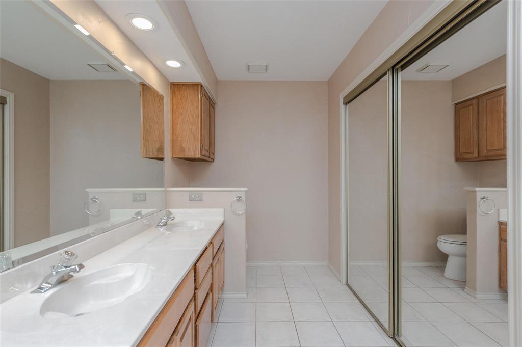 1106 Derby Run Carrollton, TX 75007 - Photo 16 of 26 a bathroom with a sink a toilet and mirror