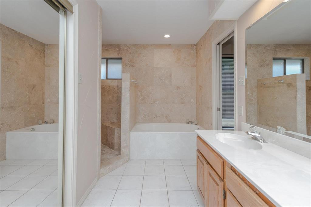 1106 Derby Run Carrollton, TX 75007 - Photo 18 of 26 a bathroom with a bathtub and a sink