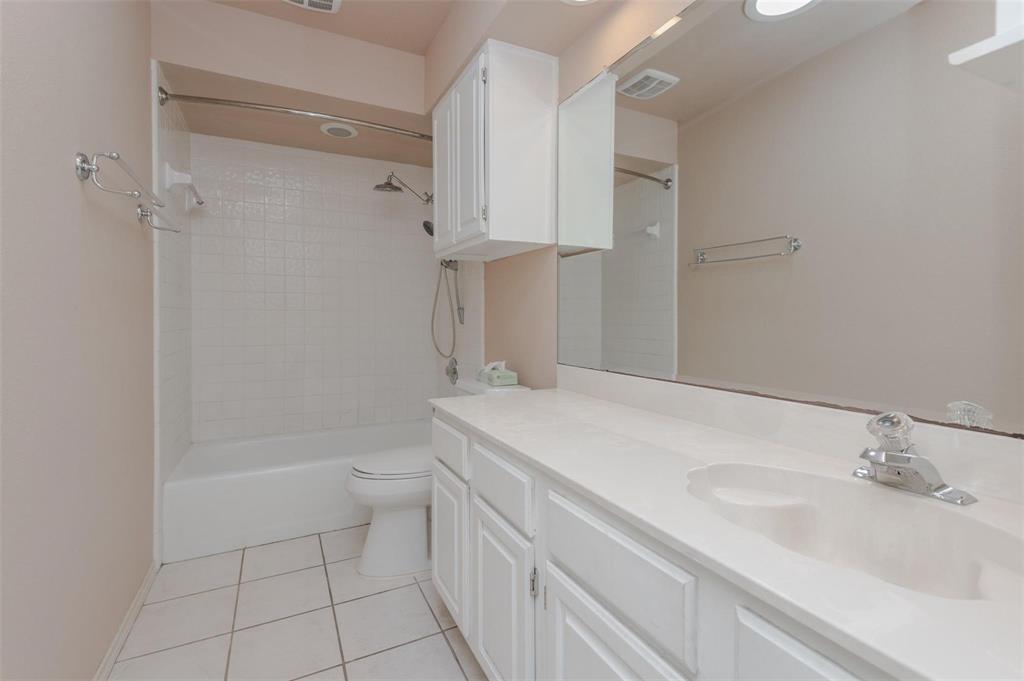 1106 Derby Run Carrollton, TX 75007 - Photo 21 of 26 a bathroom with a sink a toilet and shower