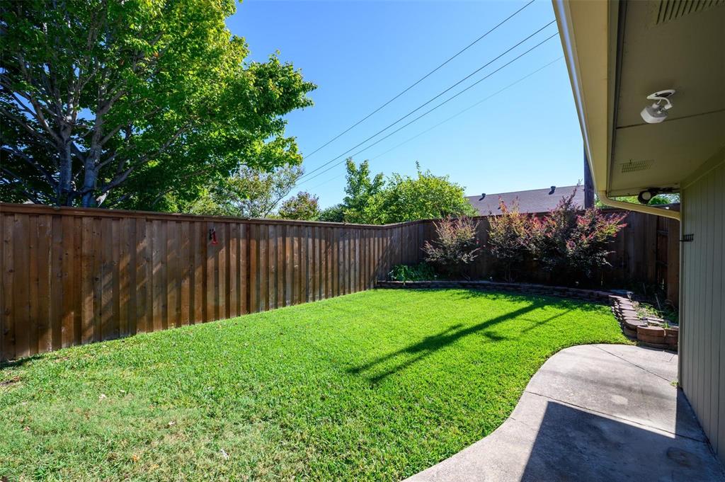 1106 Derby Run Carrollton, TX 75007 - Photo 24 of 26 a view of a backyard with wooden fence