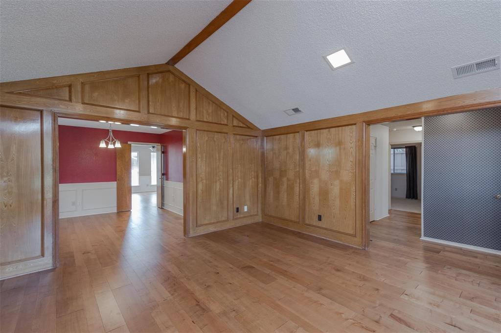 1106 Derby Run Carrollton, TX 75007 - Photo 4 of 26 a view of an empty room with wooden floor and a window