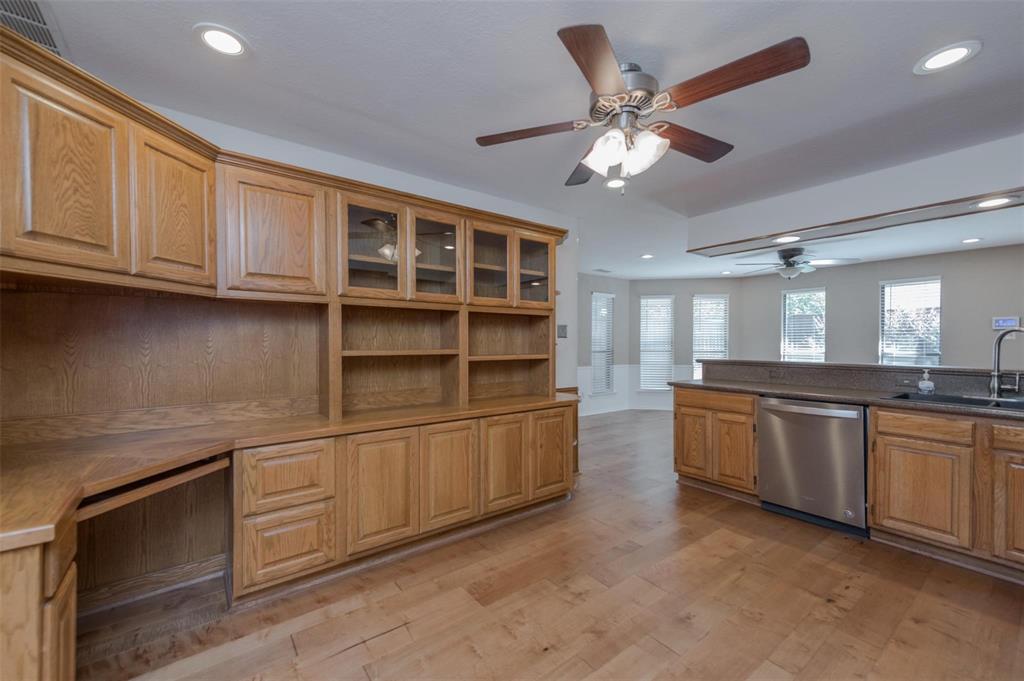 1106 Derby Run Carrollton, TX 75007 - Photo 10 of 26 a kitchen with stainless steel appliances granite countertop a cabinets and a sink