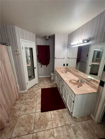 a kitchen with a stove a refrigerator and a sink