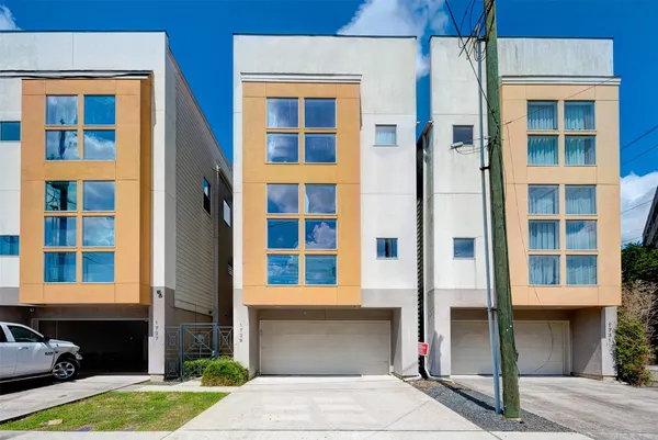 a front view of a building with a garden