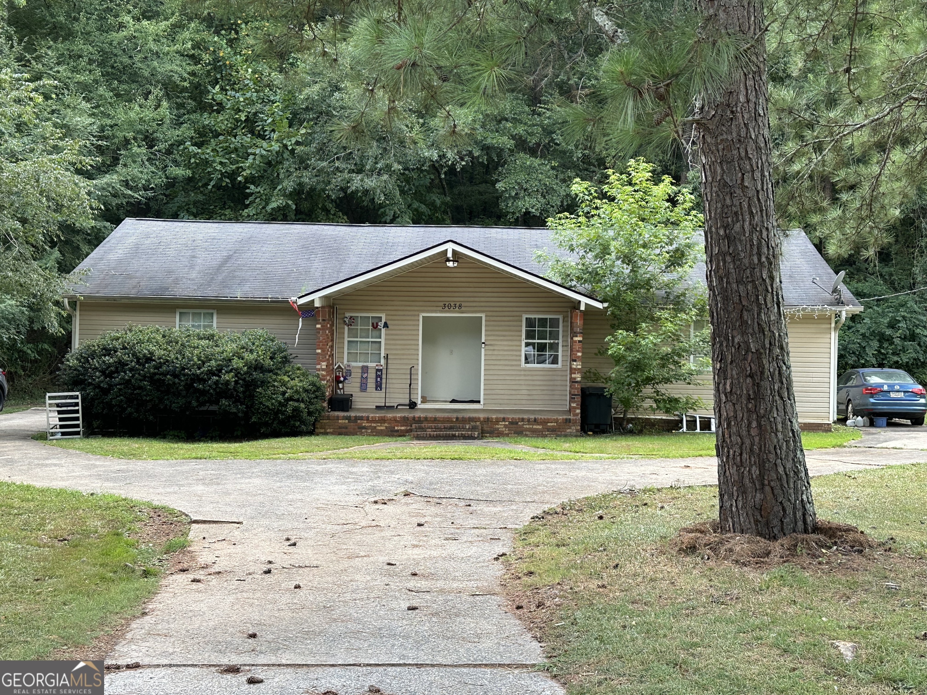 a front view of house with yard and green space