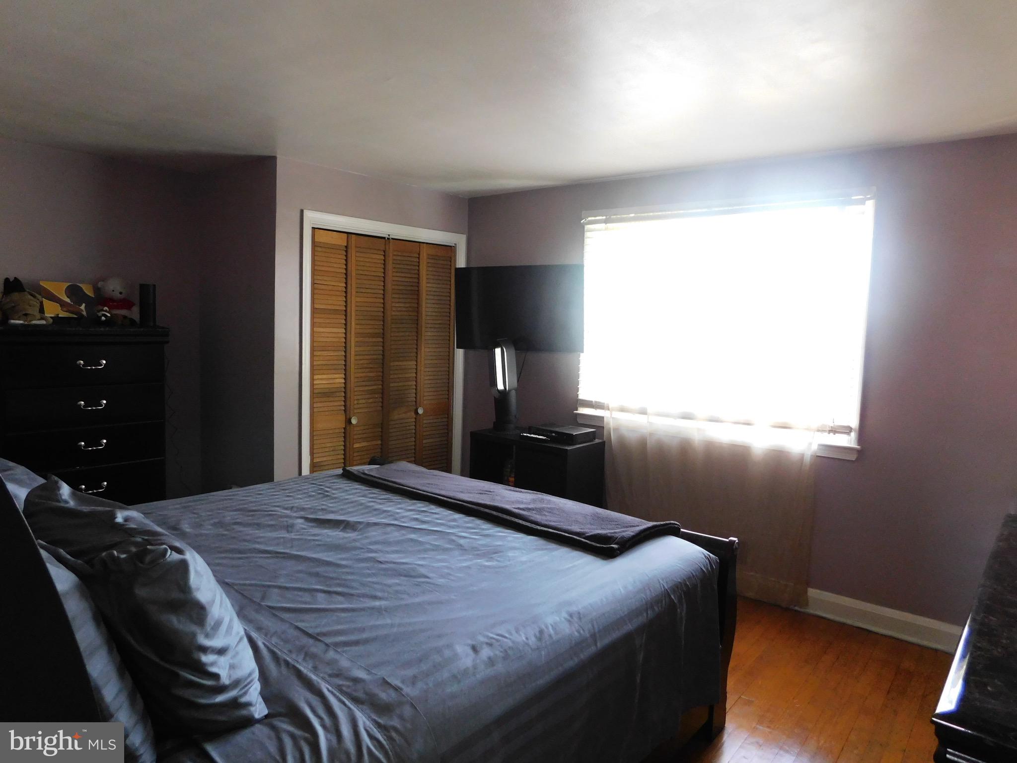 1333 Deanwood Road Baltimore, MD 21234 - Photo 20 of 40 a bedroom with a bed and wooden floor