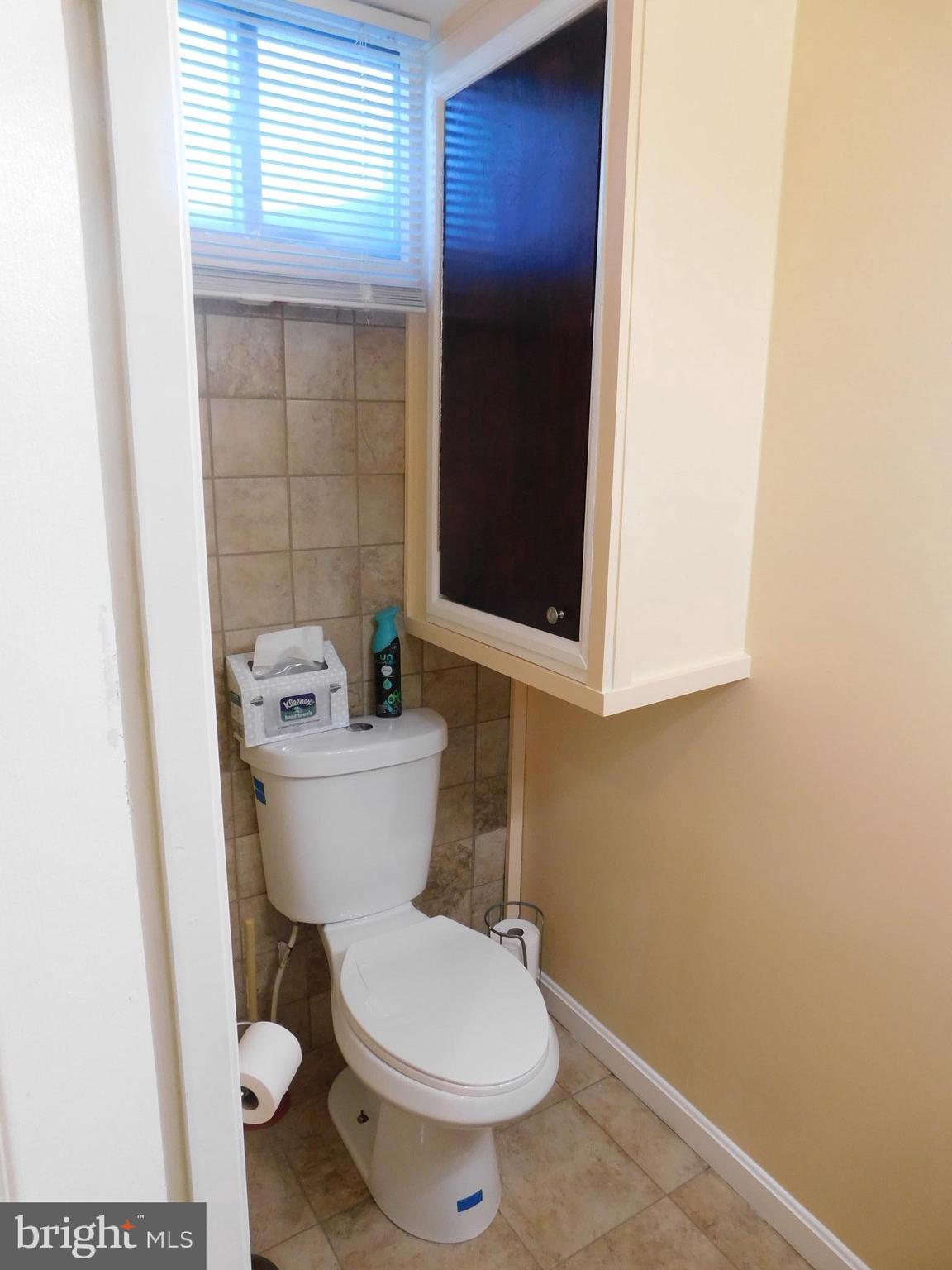 1333 Deanwood Road Baltimore, MD 21234 - Photo 8 of 40 a white toilet sitting next to a bathroom sink and vanity