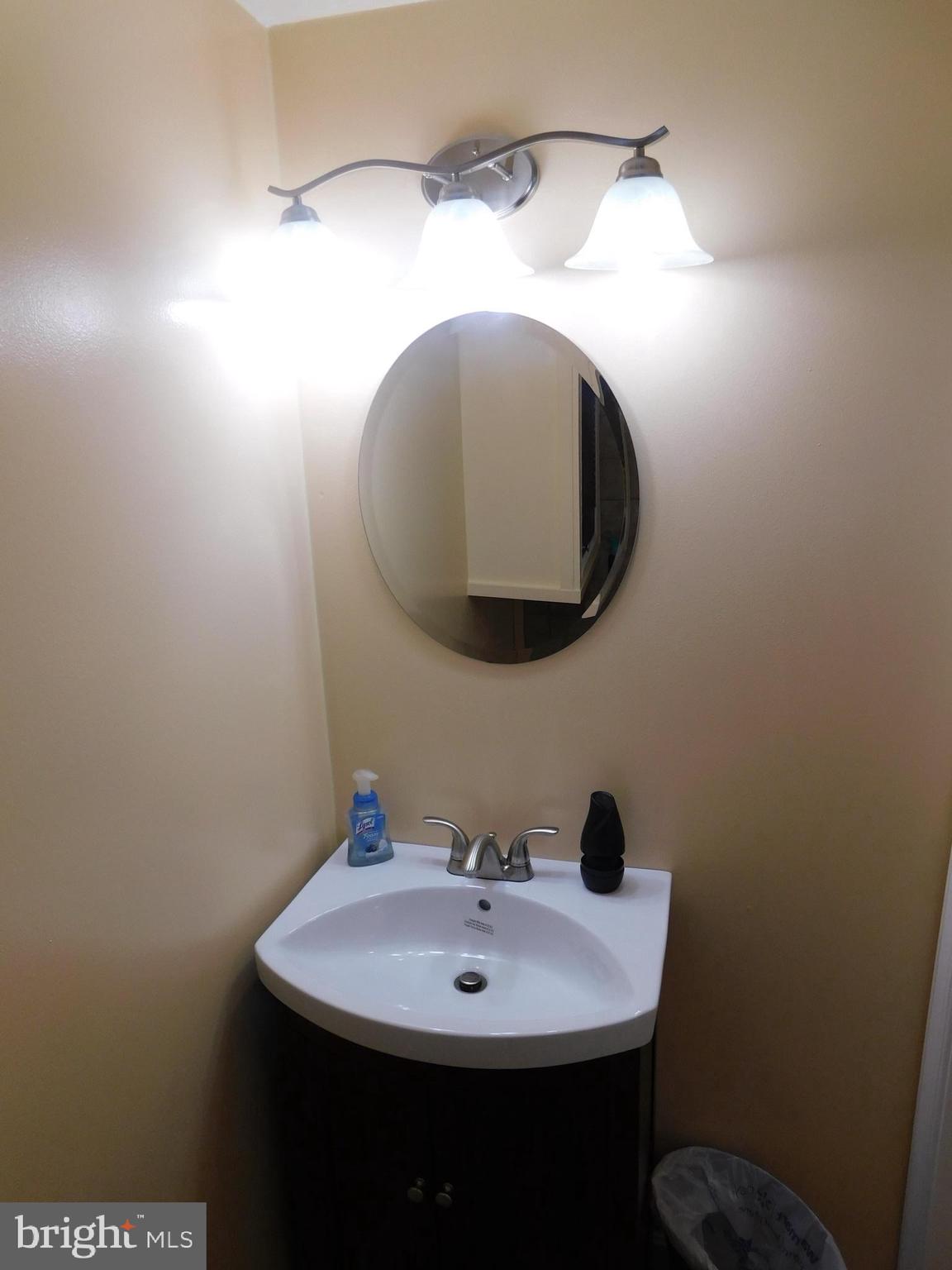 1333 Deanwood Road Baltimore, MD 21234 - Photo 9 of 40 a bathroom with a sink and mirror