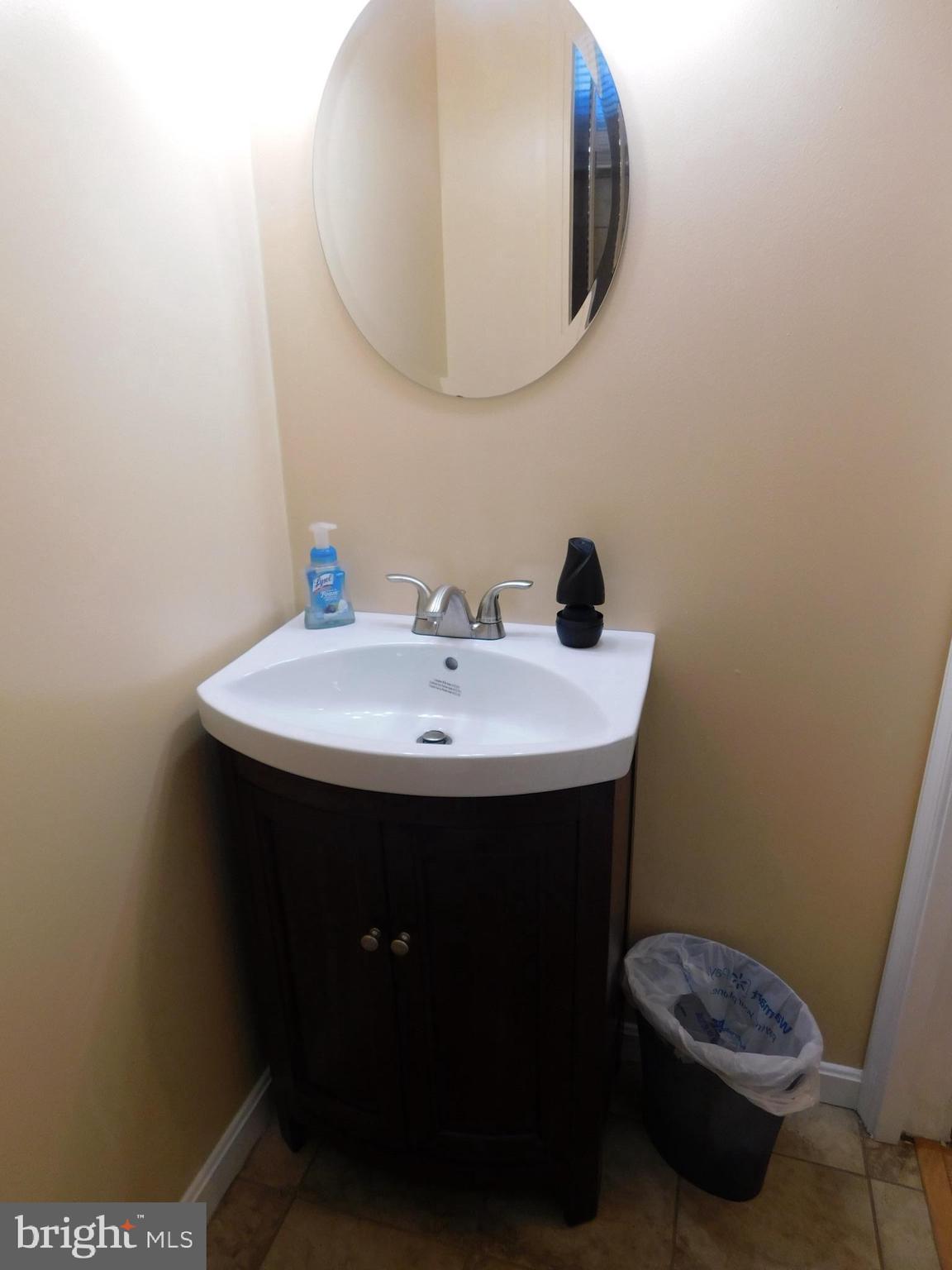 1333 Deanwood Road Baltimore, MD 21234 - Photo 10 of 40 a bathroom with a sink a mirror and a toilet