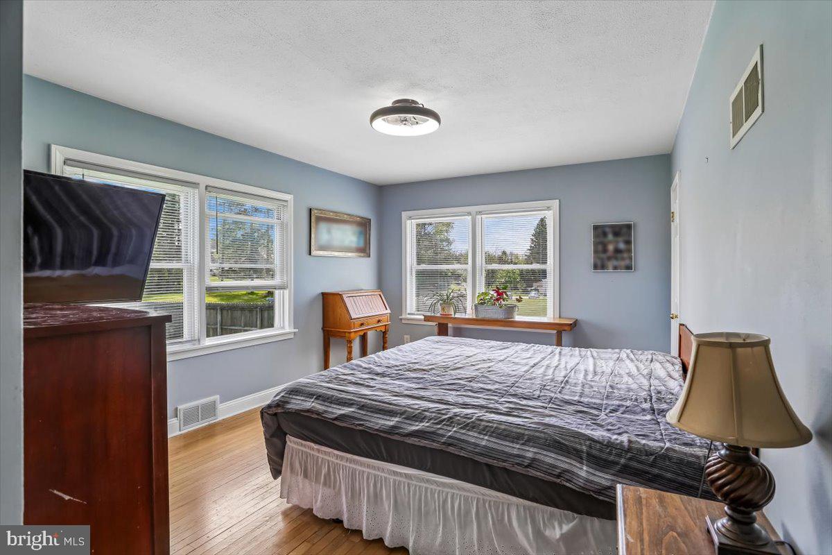 321 North 3rd Street Oakland, MD 21550 - Photo 22 of 48 a bedroom with a bed and wooden floor
