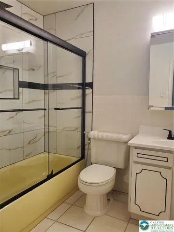a bathroom with a toilet a sink and bathtub