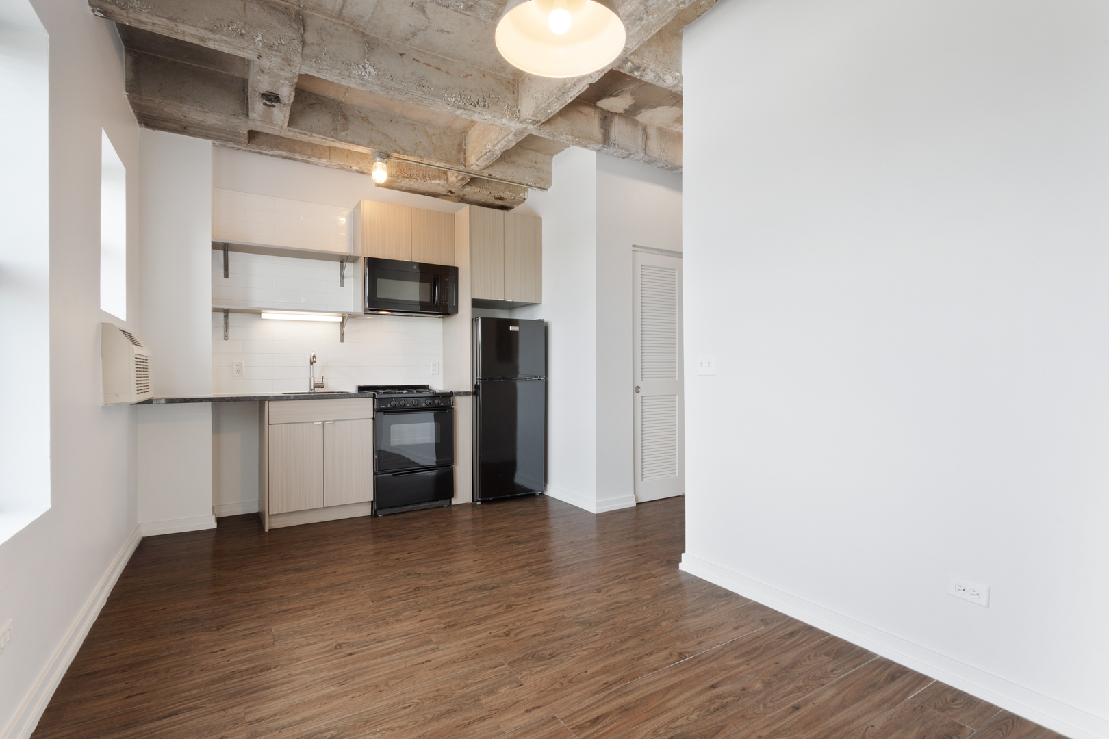 1325 West Wilson Avenue, Unit 1006 Chicago, IL 60640 - Photo 3 of 21 a kitchen with stainless steel appliances granite countertop a refrigerator and a stove