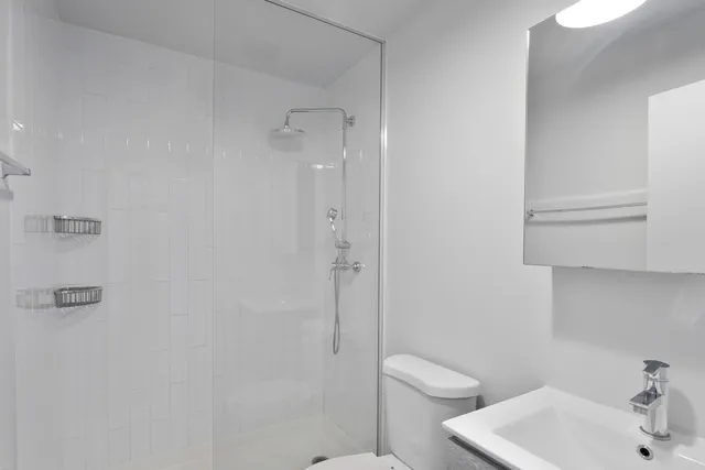 a bathroom with a toilet sink and shower